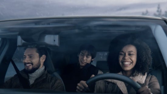 Three passengers riding in a vehicle and smiling | Benton Nissan of Oxford in Oxford AL