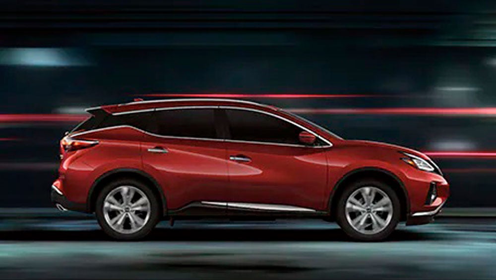 2023 Nissan Murano shown in profile driving down a street at night illustrating performance. | Benton Nissan of Oxford in Oxford AL